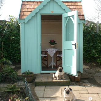 Posh wooden Gothic garden shed with cedar roof