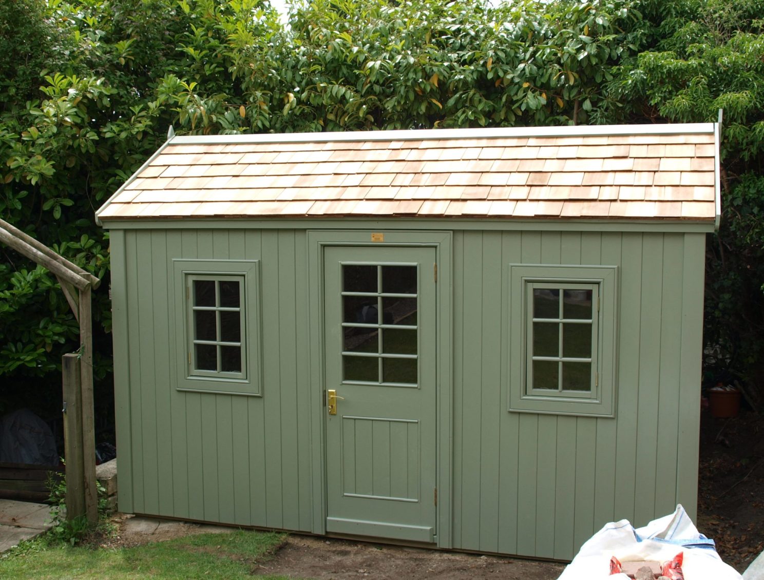 Very Posh Shed with wooden cedar shingles on roof