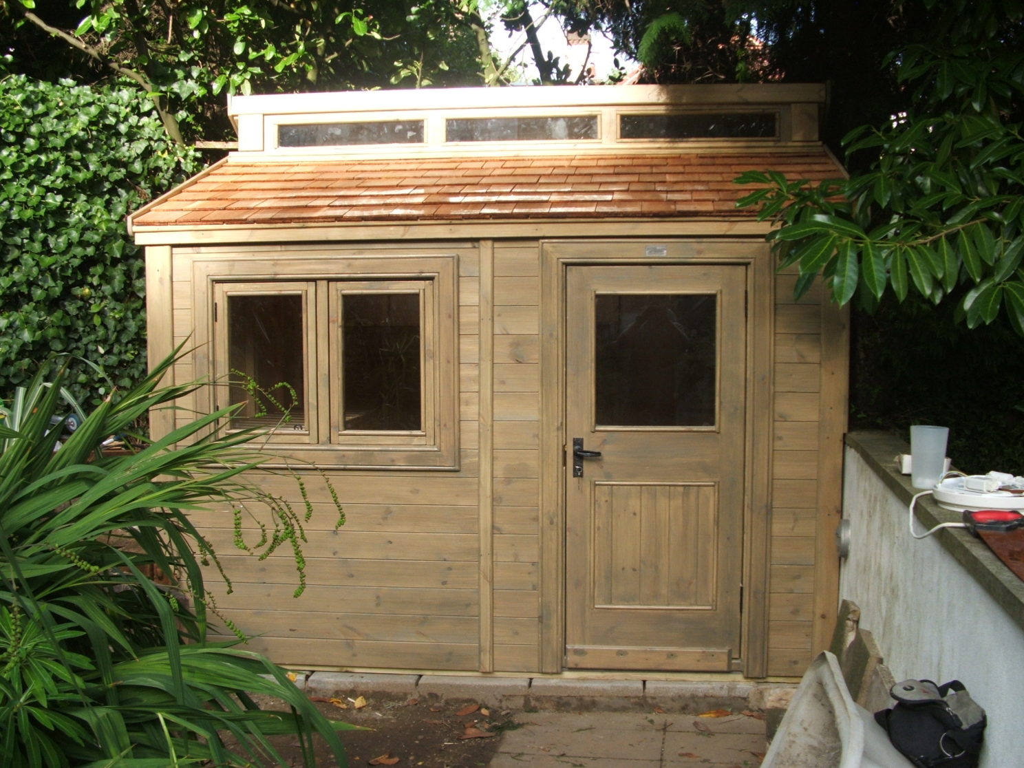 Contemporary Shed with cedar roof shingles